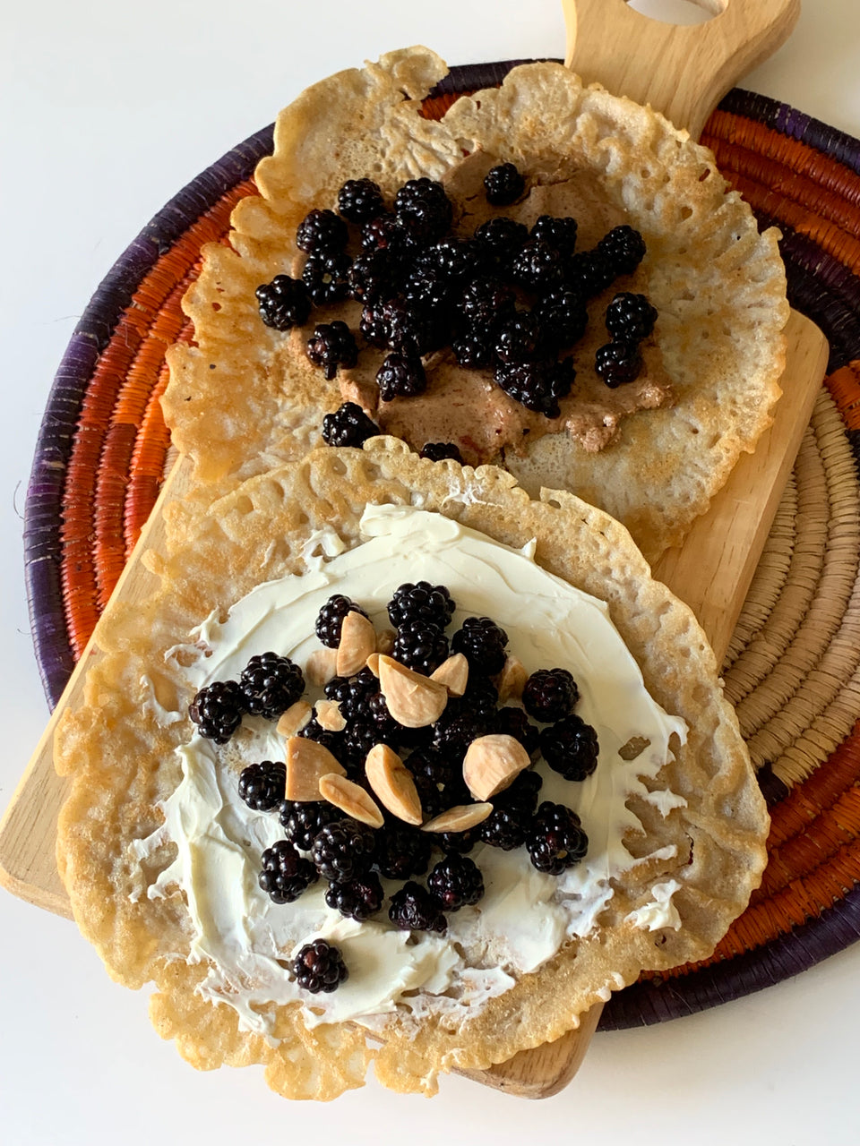 Gluten-free and vegan spongy thin Kisra with Greek yogurt or almond butter and raspberries