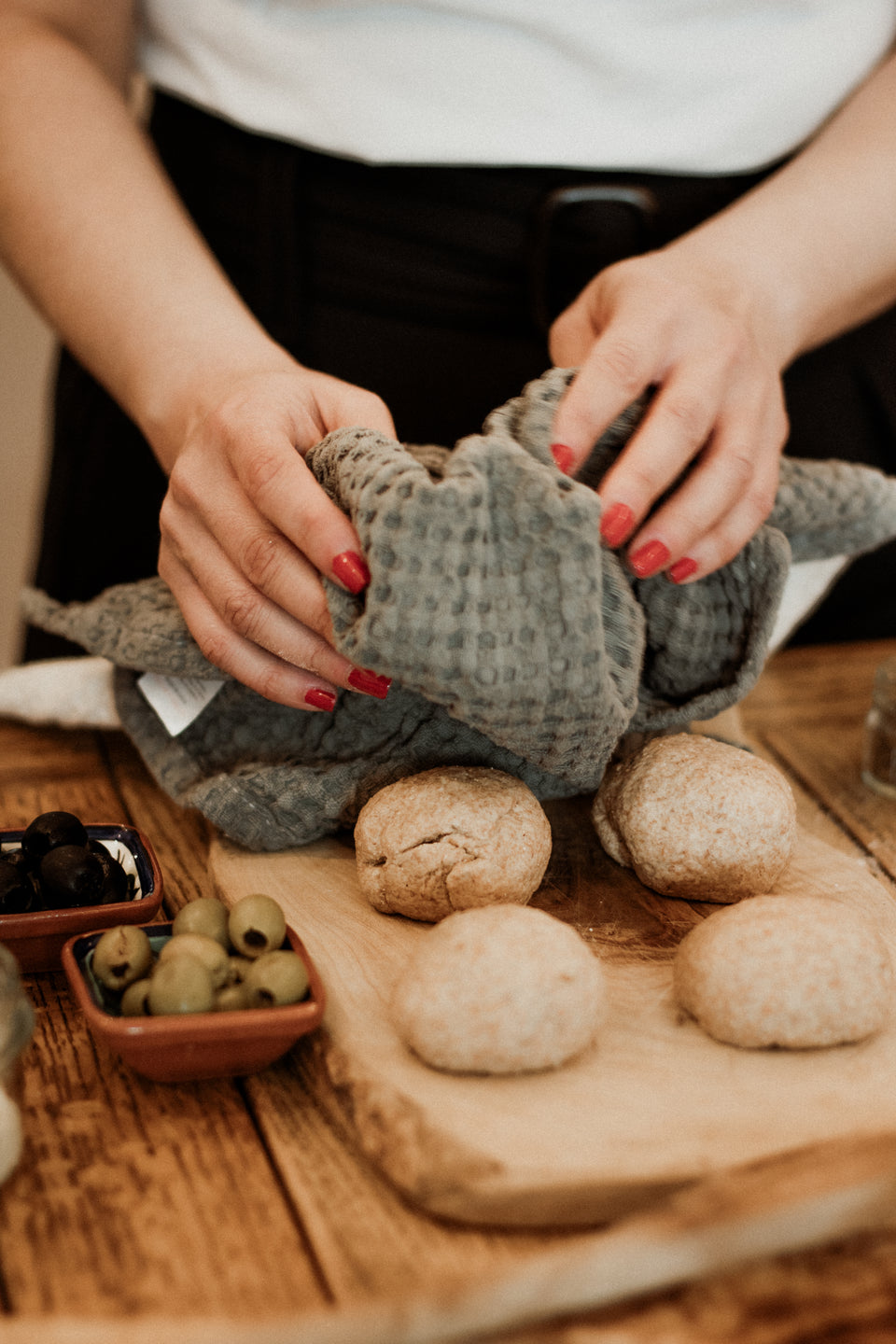 Leila is covering the dough balls How To make a bread 