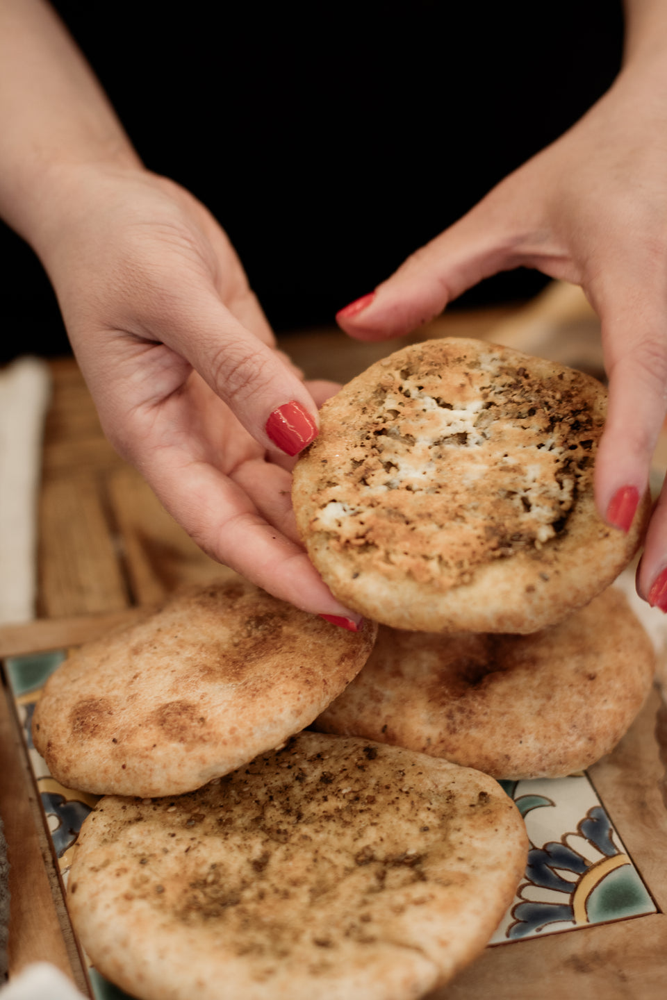 Leila is showing a freshly baked flatbread with Za'atar How To Make a bread at homw