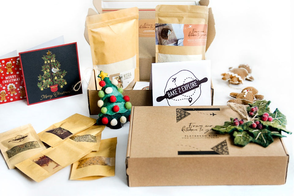 Bake2Explore Christmas gift boxes, with small packs of spices and Christmas cards.
